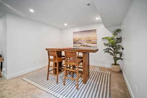 View of carpeted basement poker or dining space