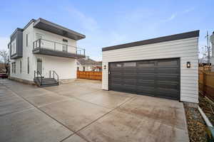 Exterior space featuring a balcony and a garage