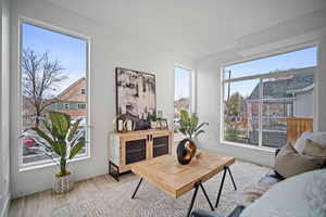 Living room with a wealth of natural light and light hardwood / wood-style floors