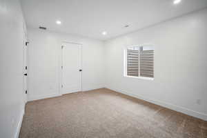 Unfurnished room featuring carpet flooring