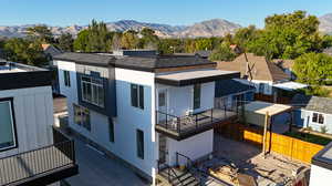 Exterior space featuring a balcony, a mountain view, and a patio area