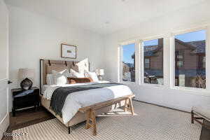 Bedroom with multiple windows and carpet floors