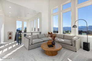 Carpeted living room with a mountain view and a high ceiling