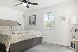 Bedroom featuring ceiling fan and light carpet