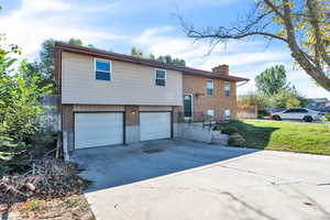 View of front of property with a front lawn and a garage