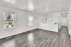 Empty room with hardwood / wood-style flooring