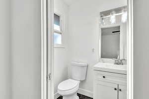 Bathroom with vanity, toilet, and tile patterned floors