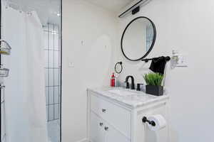 Bathroom featuring vanity and a shower with shower curtain