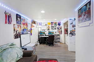 Office featuring a textured ceiling and light hardwood / wood-style floors