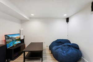 Living room featuring hardwood / wood-style flooring and a textured ceiling