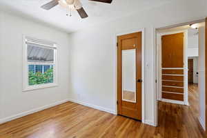 Unfurnished bedroom featuring a textured ceiling, ceiling fan, and wood-type flooring