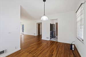 Unfurnished dining area featuring hardwood / wood-style floors