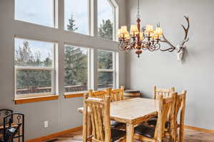 Dining space featuring a notable chandelier and light wood-type flooring