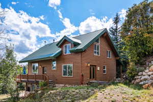 View of property exterior featuring a wooden deck