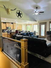 Living room featuring lofted ceiling and ceiling fan