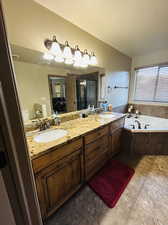 Bathroom with shower with separate bathtub, a textured ceiling, and vanity