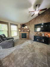 Living room featuring carpet flooring, ceiling fan, and a textured ceiling