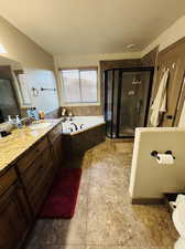 Bathroom featuring vanity, a textured ceiling, and independent shower and bath