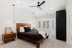 Primary bedroom with vaulted ceiling