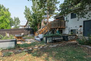 View of yard featuring an outdoor fire pit and a deck