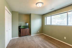 Unfurnished bedroom featuring a closet and carpet flooring