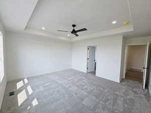 Interior space featuring ceiling fan and a tray ceiling