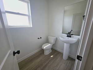 Bathroom featuring toilet and hardwood / wood-style floors