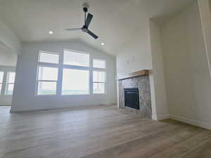 Unfurnished living room featuring ceiling fan, plenty of natural light, and light hardwood / wood-style floors