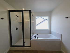 Bathroom featuring a textured ceiling and independent shower and bath