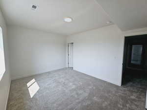 Carpeted empty room with a textured ceiling