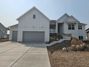 View of front of house featuring a garage and covered porch