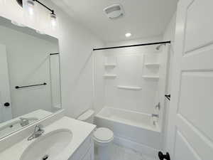 Second primary bedroom with full bathing tub / shower combination, vanity, and light marble finish flooring