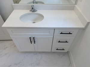 Jack and Jill bathroom featuring quartz vanity