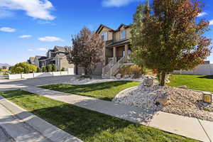 Obstructed view of property with a garage and a front yard