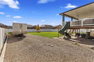 View of yard with a playground and a patio area