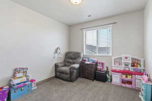 Game room featuring light carpet