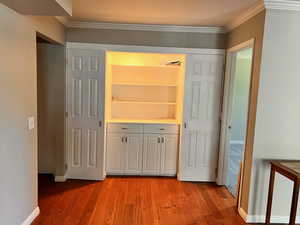 Interior space featuring crown molding and hardwood / wood-style floors