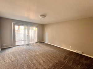 Unfurnished room featuring carpet