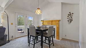 Dining room featuring light carpet and vaulted ceiling