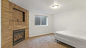 Bedroom featuring a textured ceiling, wooden walls, and carpet floors