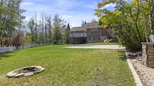 View of yard with a patio and an outdoor fire pit