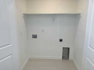 Laundry room featuring hookup for a washing machine, light tile patterned flooring, and electric dryer hookup