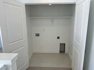 Laundry room featuring light tile patterned floors, electric dryer hookup, and washer hookup