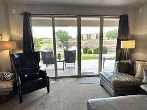 Sitting room featuring plenty of natural light and carpet