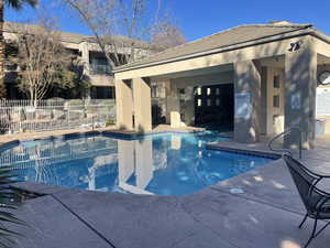 View of community swimming pool with a patio