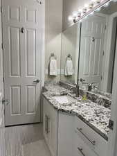 Bathroom featuring vanity and tile patterned flooring