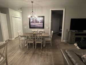 Dining space featuring luxury vinyl plank flooring and an inviting chandelier