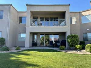 Back of house featuring a patio and lawn area.