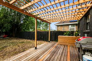 Deck with a grill and a pergola