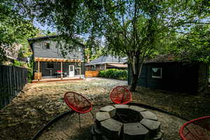 View of yard with a wooden deck and a fire pit